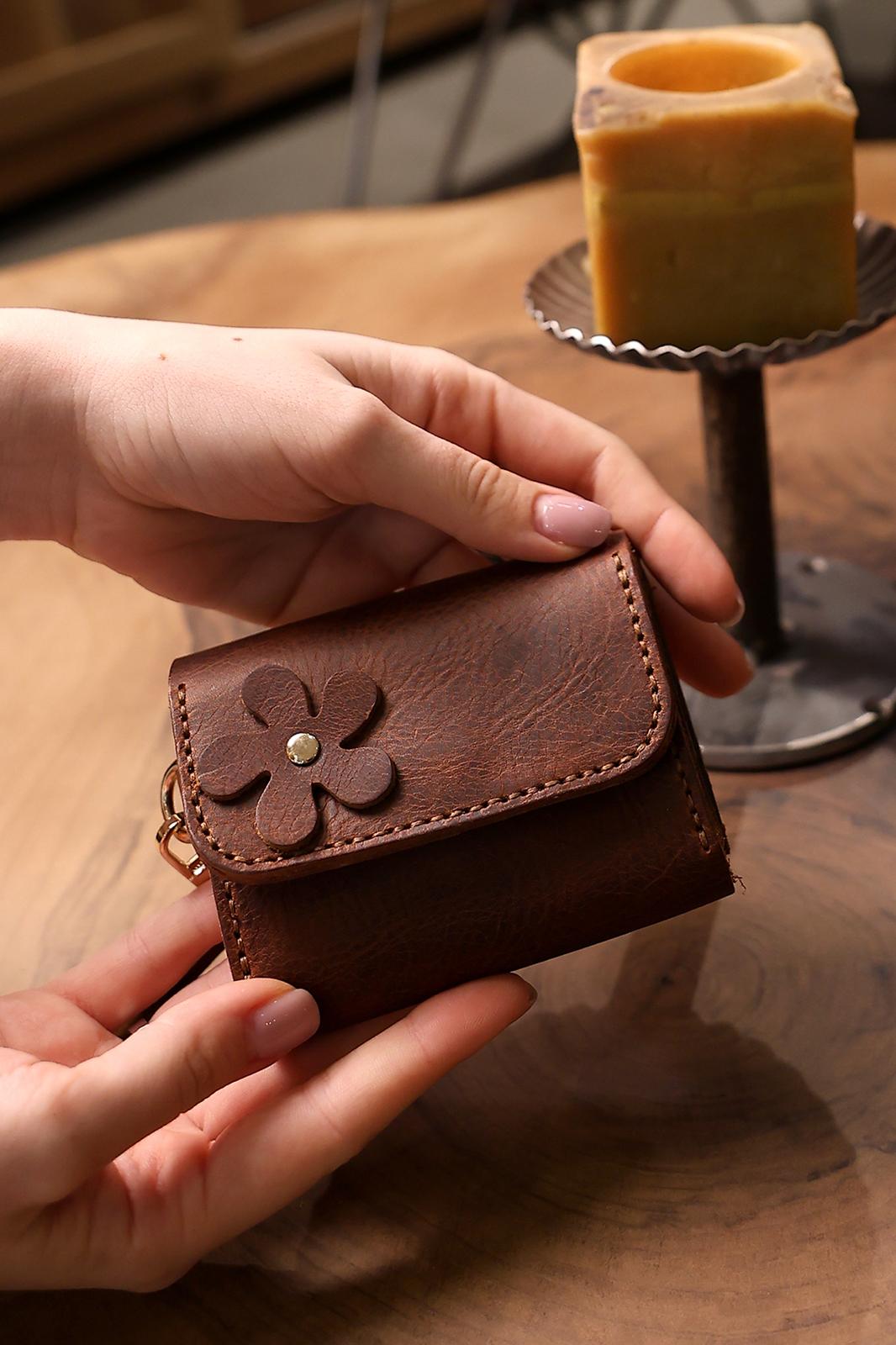 Hands holding a personalized Craftivor leather wallet